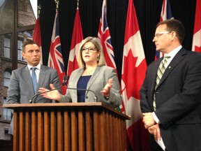 NDP Leader Andrea Horwath stands with Progressive Conservative Leader Patrick Brown, left, and Green Party Leader Mike Schreiner, right, during an event Tuesday, April 19, 2016 to call for an advisory panel on political finance reform. (Shawn Jeffords/Toronto Sun)