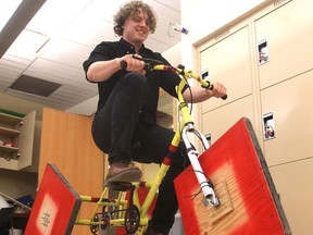 Alex Buchanan, a first-year engineering student at Queen's University, rides a square-wheeled tricycle he and a team of students built for a school project. Three of the trikes will be at the upcoming Science Rendezvous. (Michael Lea/The Whig-Standard)