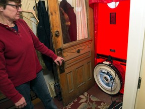 Jaymi Ermitage, a certified energy adviser contracted by Red Squirrel Conservation Services in Kingston, constructs a “blower door” as part of an energy audit for a residential home. Energy audits are one of the requirements for Union Gas’s Home Reno Rebate Program, which was introduced to the Kingston area on April 1. (Hannah Lawson/For The Whig-Standard)