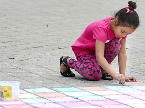 Leah Russell, 6, uses sidewalk chalk during an outdoor break with classmates at the Gallery Stratford's Arts Alive program at Stratford St. Michael. (The Beacon Herald file photo)