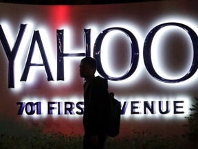 In this Nov. 5, 2014, file photo, a person walks in front of a Yahoo sign at the company's headquarters in Sunnyvale, Calif. (AP Photo/Marcio Jose Sanchez, File)