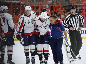 Capitals defenceman Brooks Orpik (44) is helped off the ice after an injury during Game 3 in the first round playoff series against the Flyers in Philadelphia on Monday, April 18, 2016. (Matt Slocum/AP Photo)