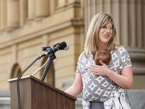 MLA Stephanie McLean, Minister of Service Alberta and Minister of Status of Women speaks while holding son Patrick on the steps of the Alberta Legislature in Edmonton, Alta., on Tuesday April 19, 2016 during an event held to mark the centennial of equal voting. Photo by Ian Kucerak