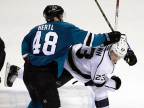San Jose Sharks forward Tomas Hertl fights with L.A. Kings forward Dustin Brown during third-period NHL playoff action in San Jose on April 18, 2016. (AP Photo/Marcio Jose Sanchez)