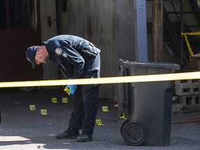 Toronto Police at the scene behind a butcher shop on Broadview Ave. after remains were found Tuesday, April 19, 2016. (CRAIG ROBERTSON/TORONTO SUN)