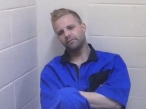 Edmonton Police Service Det. Ken Schindeler interviews Steven Vollrath (pictured in blue coveralls) at the Calgary Remand Centre on May 26, 2015, about his alleged involvement in the kidnapping and thumb-chopping of Richard Suter. (Screen capture of court video)
