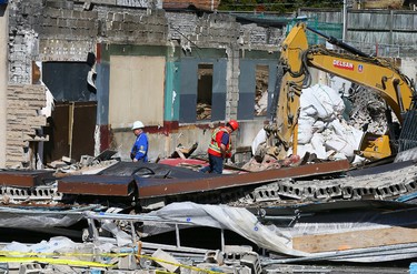 Inspectors on scene after a wall collapsed during demolition onto the street near Eglinton and Bathurst  on Tuesday April 19, 2016. Dave Abel/Toronto Sun/Postmedia Network
