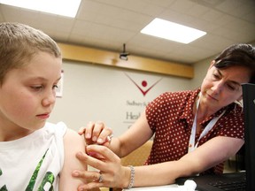 Gino Donato/Sudbury Star
Ten-year-old Jacob Hogue gets his hepatitis A vaccine from registered nurse Tanya Hunter at the Sudbury and District Health Unit on Tuesday. Sudburians scrambled to the health unit for the vaccines after learning of the Nature's Touch Organic Berry Cherry Blend frozen berries recently recalled by Costco. Samples of the berries were given out at the Sudbury Costco on March 22 and 23.