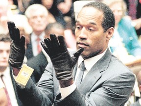 In this June 21, 1995, file photo, O.J. Simpson holds up his hands before the jury after putting on a new pair of gloves similar to the infamous bloody gloves during his double-murder trial in Los Angeles. (AP Photo/Vince Bucci, Pool, File)