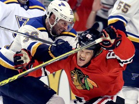 Chicago Blackhawks winger Andrew Shaw, right, is hit by St. Louis Blues winger Troy Brouwer during Game 4 of their first-round Stanley Cup playoff series Tuesday, April 19, 2016, in Chicago. (AP Photo/Nam Y. Huh)