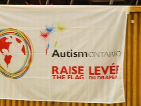 Submitted Photo
An Autism Awareness Day flag provided by Autism Ontario hangs in the auditorium at St. Joseph Catholic School in Belleville. The school was provided the flag for earning a minimum of $250 as part of Autism Awareness Day.