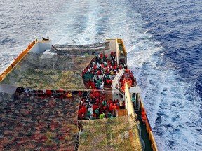 In this Sept 2, 2015 file photo, migrants crowd the bridge of the Norwegian ship Siem Pilot sailing along the Mediterranean sea. (AP Photo/Gregorio Borgia, File)