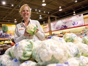 Trish Nemeth holds up a head of cauliflower at the Metro grocery store on Adelaide Street North in London, Ont. in this March 6, 2015 file photo. (CRAIG GLOVER/The London Free Press/Postmedia Network)