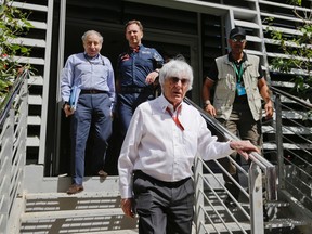 Bernie Ecclestone, chief executive of the Formula One Group, foreground, is followed by FIA president Jean Todt, left, and Red Bull team principal Christian Horner as they leave the press center after a meeting prior to the start of the Bahrain Formula One Grand Prix, at the Formula One Bahrain International Circuit, in Sakhir, Bahrain, Sunday, April 3, 2016. (AP Photo/Luca Bruno)