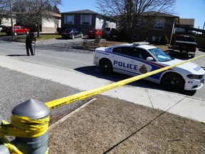 City police and Special Investigations Unit at 261 Middlefield Rd. in the southeast end of Peterborough, Ont.  surrounded by police tape on Saturday, March 19, 2016 after a stabbing late Friday night that left a 52-year-old woman dead followed by the shooting of a 25-year-old man at the scene by Peterborough Police officers. Clifford Skarstedt/Peterborough Examiner/Postmedia Network