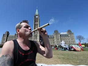 Stanley Duhaime smokes marijuana virtually all the time due to severe pain the result of a head on car crash October 2007. His joint drew a lot of interest from those gathered on Parliament Hill for the annual protest of marijuana laws, April 20, 2016. (Wayne Cuddington photo)