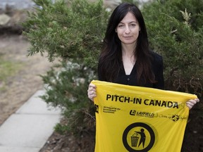 Alia Tulloch, plan manager for Sustainability Kingston, holds a Pitch-In Canada garbage bag on Monday. (Nick Tardif/The Whig-Standard)