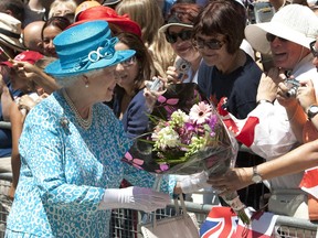 Queen Elizabeth greets crowds outside St. James Cathedral in Toronto July 4, 2010, after attending morning church services. (REUTERS/Fred Thornhill)