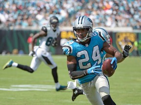 Carolina Panthers cornerback Josh Norman runs back an interception against the Jacksonville Jaguars for a 30-yard touchdown during the second half of an NFL football game in Jacksonville, Fla.