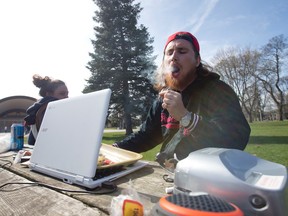 A man who gave his name as Crutch 420 smokes a marijuana cigarette at a table in Victoria Park as pot advocates celebrate "420" in the downtown park in London, Ont. on Wednesday April 20, 2016. (CRAIG GLOVER, The London Free Press)