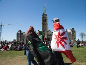 Stylized flags flapped in the smokey air during the annual 4-20 marijuana rally on Parliament Hill. Wayne Cuddington/Postmedia