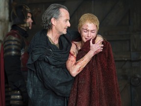 In this image released by HBO, Anton Lesser, left, as Qyburn, and Lena Headey, as Cersei Lannister, appear in a scene from "Game of Thrones." (Macall B. Polay/HBO via AP)