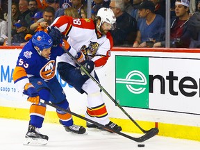 Islanders centre Casey Cizikas (left) and Panthers right wing Jaromir Jagr (right) battle for the puck during the first period of Game 4 of the first round of the NHL playoffs at Barclays Center in Brooklyn, N.Y., on Wednesday, April 20, 2016. (Andy Marlin/USA TODAY Sports)