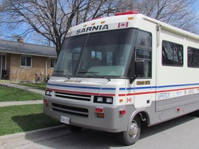 A mobile police command post is parked outside 410 Kathleen Ave., where yellow caution tape was up on Tuesday April 19, 2016 in Sarnia, Ont. Sarnia Police are investigating the suspicious death of a 29-year-old man, after being called out to Kathleen Avenue at 2:35 a.m. Tuesday. (Paul Morden/Sarnia Observer/Postmedia Network)