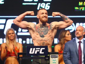 Conor McGregor flexes during weigh-ins for his UFC 196 fight against Nate Diaz at MGM Grand Garden Arena. (Mark J. Rebilas/USA TODAY Sports)