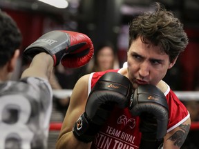 Canadian Prime Minister Justin Trudeau dodges a punch as he spars in the ring at Gleason's Boxing Gym in the Brooklyn borough of New York, U.S., April 21, 2016. REUTERS/Carlo Allegri