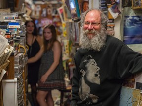 Brian Lipsin stands in his store, Brian’s Record Option, which is the location and subject of the play New & Used, starring Audrey Sturino, back left, and Hannah Komlodi. (Nick Tardif/For The Whig-Standard)