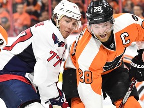 Philadelphia Flyers center Claude Giroux and Washington Capitals right winger T.J. Oshie battle for the puck during third-period NHL playoff action at Wells Fargo Center in Philadelphia on April 20, 2016. (Eric Hartline/USA TODAY Sports)