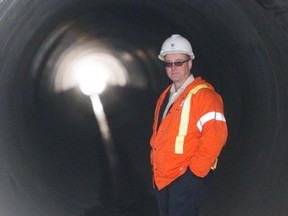 Paul Choma, the city?s construction administration engineer, shows off the new tunnel running below London?s CN railyard to link new storm sewers north of the tracks with pipes to the south leading to the Thames River. (MIKE HENSEN, The London Free Press)