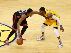 Toronto Raptors forward DeMar DeRozan is guarded by Indiana Pacers forward Paul George in the first quarter in game three of the first round of the 2016 NBA Playoffs at Bankers Life Fieldhouse. (Brian Spurlock/USA TODAY Sports)