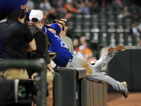 Toronto Blue Jays third baseman Josh Donaldson dives into the crowd for a foul ball in the third inning against the Baltimore Orioles at Oriole Park at Camden Yards. (Evan Habeeb/USA TODAY Sports)