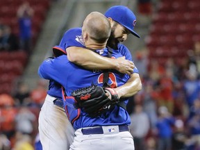 Chicago Cubs starting pitcher Jake Arrieta, left, celebrates with catcher David Ross after the final out of his no-hitter in a game against the Cincinnati Reds, Thursday, April 21, 2016, in Cincinnati. (AP Photo/John Minchillo)