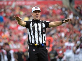 In this Sunday, Nov. 9, 2014 file photo, official Clete Blakeman calls a penalty during the first half of an NFL game between the Tampa Bay Buccaneers and Atlanta Falcons in Tampa, Fla. (AP Photo/Phelan M. Ebenhack, File)