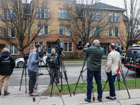 Media stand in front of an townhouse on Colborne St. in Oshawa where a 23-year-old man was shot outside the address and a 7-year-old-boy inside the address was shot by a bullet that entered the house. Both were rushed to hospital with non-life-threatening injuries on Friday, April 22, 2016. Dave Thomas/Toronto Sun/Postmedia Network