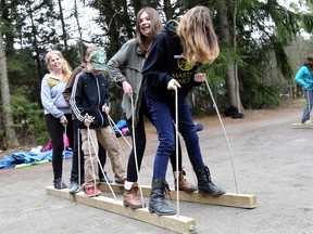 Emily Mountney-Lessard/The Intelligencer
Students attempt to step in tandem in order to move these pieces of wood from one area to another during this leadership and team building exercise at the Frink Centre, on Friday in Plainfield. Students from across the Lakeshore and Catholic District School Board took part in the Best Foot Forward Conference there, focusing on outdoor education.