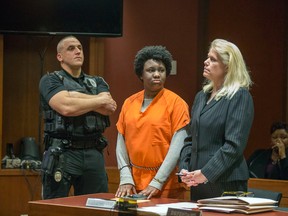 With her mother Juana Sully seated behind her, Hyphernkemberly Dorvilier, stands between a sheriff's deputy and her defense attorney Karen Thek as she listens to the charges against her. Dorvilier pleaded guilty Monday, Feb. 29, 2016, in Mount Holly, N.J., to aggravated manslaughter. She had previously pleaded not guilty to a murder charge. Authorities say the 23-year-old Pemberton Township resident doused her newborn with accelerant and set her on fire in January 2015. The baby had third-degree burns over 60 percent of her body. She died two hours after she was flown to a Philadelphia hospital. (Ed Hille/The Philadelphia Inquirer via AP)