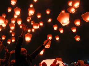 Hundreds of people release lanterns into the air in hopes of good fortune and prosperity at the traditional lantern festival during the Chinese New Year in the Pingxi district of New Taipei City, Taiwan, Monday, Feb. 22, 2016. (AP Photo/Chiang Ying-ying)