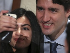 Prime Minister Justin Trudeau poses for a photo with a woman after he spoke to students at New York University in New York, U.S., April 21, 2016. (REUTERS/Carlo Allegri)