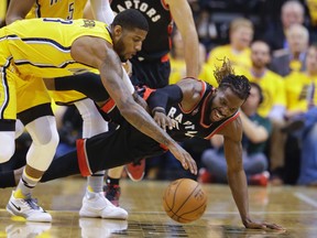 Raptors forward DeMarre Carroll (right) and Pacers forward Paul George go for a loose ball in Game 3. (ap)