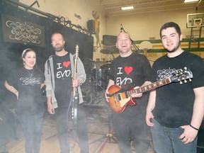 Sean and Scott Anderson of the Juno award-winning Canadian rock band Finger Eleven chat with Evolutionary band technicians Cassidy Clarke, left, and Cory Blanchard prior to a concert by Evolutionary at Confederation Secondary School in Val Caron on Friday. The Anderson brothers were in attendance with about 500 students from the Rainbow District School Board at the annual Reading Rocks Concert.(John Lappa/Sudbury Star)