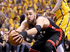 Raptors’ Jonas Valanciunas reaches for a loose ball in Game 3. The big centre has averaged 16 rebounds in the series.  (AFP)
