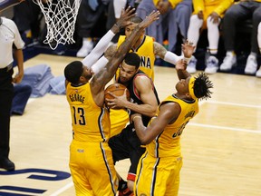 Raptors guard Cory Joseph (centre) is guarded by Pacers forward Paul George (13) and centre Myles Turner (33) during second half NBA playoff action in Indianapolis on Thursday, April 21, 2016. (Brian Spurlock/USA TODAY Sports)