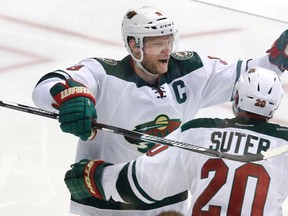 Wild centre Mikko Koivu (9) celebrates his goal with defenceman Ryan Suter (20) during overtime in Game 5 in the first round of the NHL playoffs against the Stars in Dallas on Friday, April 22, 2016. (LM Otero/AP Photo)