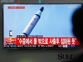 A man watches a TV news program showing a file footage of a missile launch conducted by North Korea, at the Seoul Train Station in Seoul, South Korea, Saturday, April 23, 2016. North Korea on Saturday fired what appeared to be a ballistic missile from a submarine off its northeast coast, South Korean defense officials said, Pyongyang's latest effort to expand its military might in the face of pressure by its neighbors and Washington. The Korean letters at top left read: "North Korea fires a submarine-launched ballistic missile or SLBM." (AP Photo/Lee Jin-man)