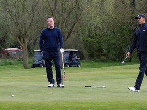 President Barack Obama and Britain's Prime Minister David Cameron react to the president missing a put on the third green at the Grove Golf Course in Hertfordshire, England, Saturday, April 23, 2016. (AP Photo/Carolyn Kaster)