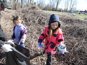 Shane Beals and his daughters,  Leah Beals, six, and Jade Beals, four, were among a legion of residents from the across the region who were out hauling bags stuffed with all kinds of waste and litter collected for the Quinte Trash Bash event.